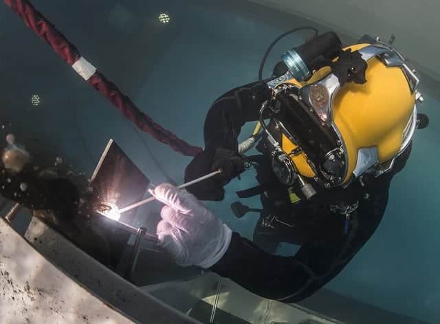 image of underwater welder welding