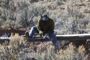 Stick welder repairs a makeshift bridge on the spot.