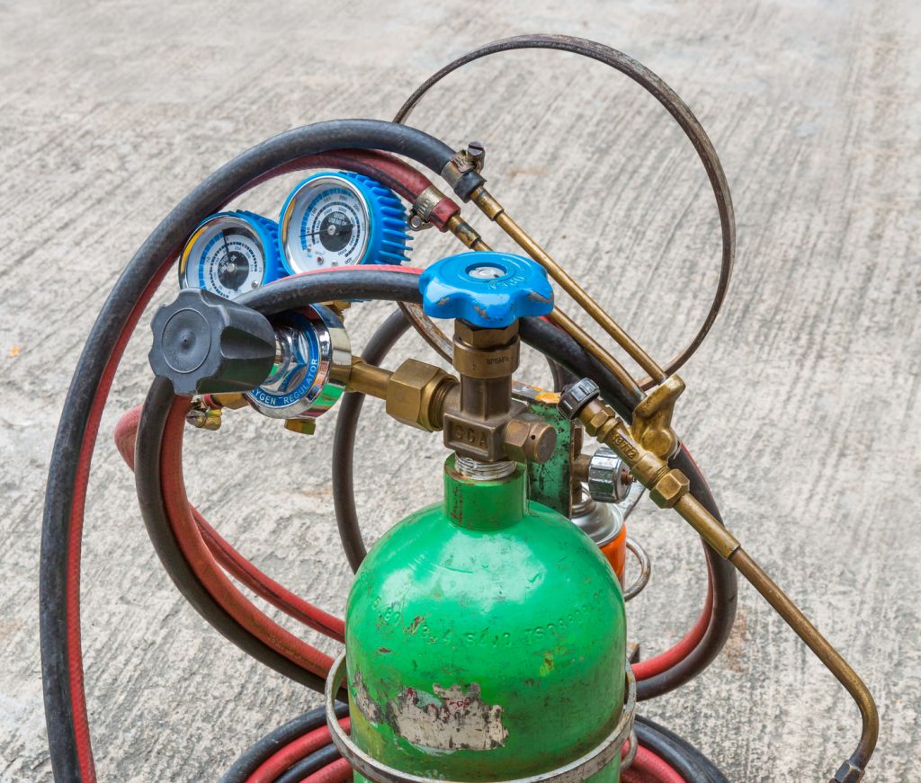 close up small gas welding kit on grunge concrete floor