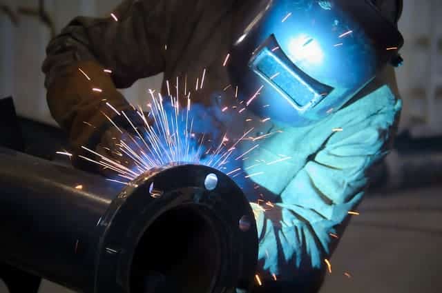 image of a welder welding a pipe