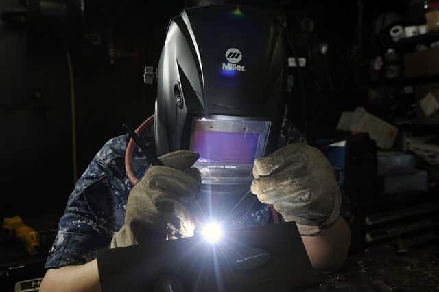 Image of a welder using a TIG welding technique on aluminum