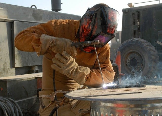 Image of a welder working with stick welder.
