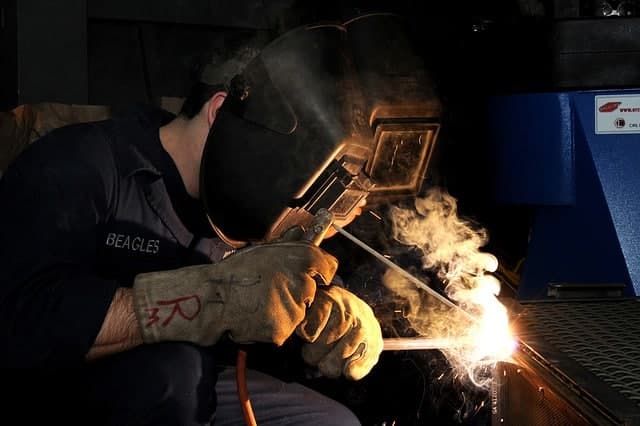 image of a worker making a stick weld