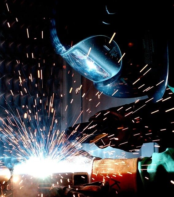 image of a worker laying a MIG weld