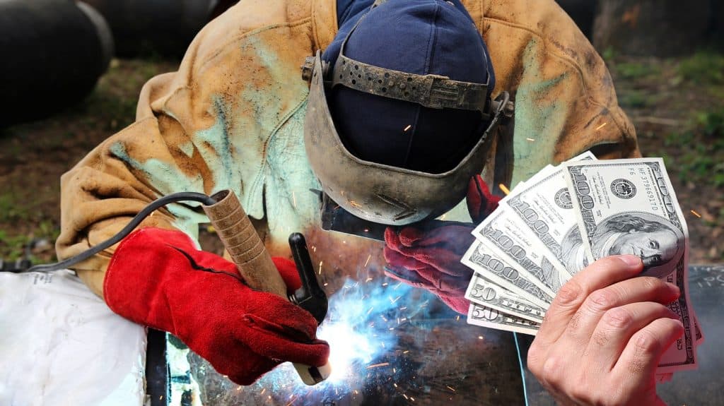 image of a welder holding money
