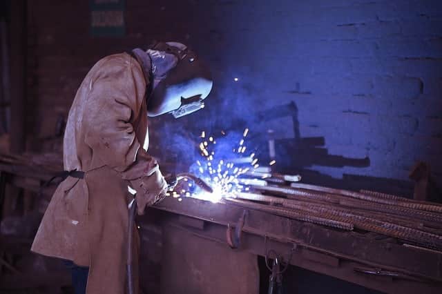 image of a welder working on mild construction steel