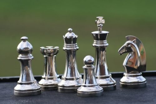 image of chess pieces made of white metals