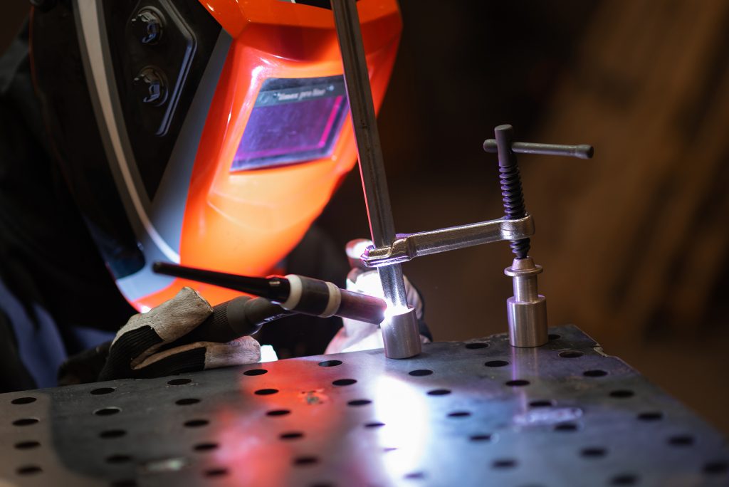 image of welder working at best welding table