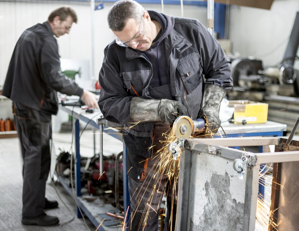 Mmage of two workers in the metal fabrication shop