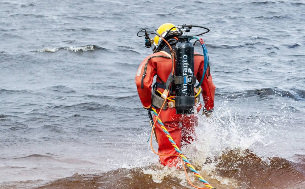 image of a commercial diver walking into the sea