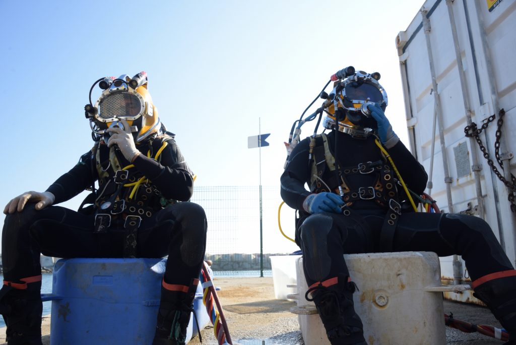 image of two commercial divers getting ready to work