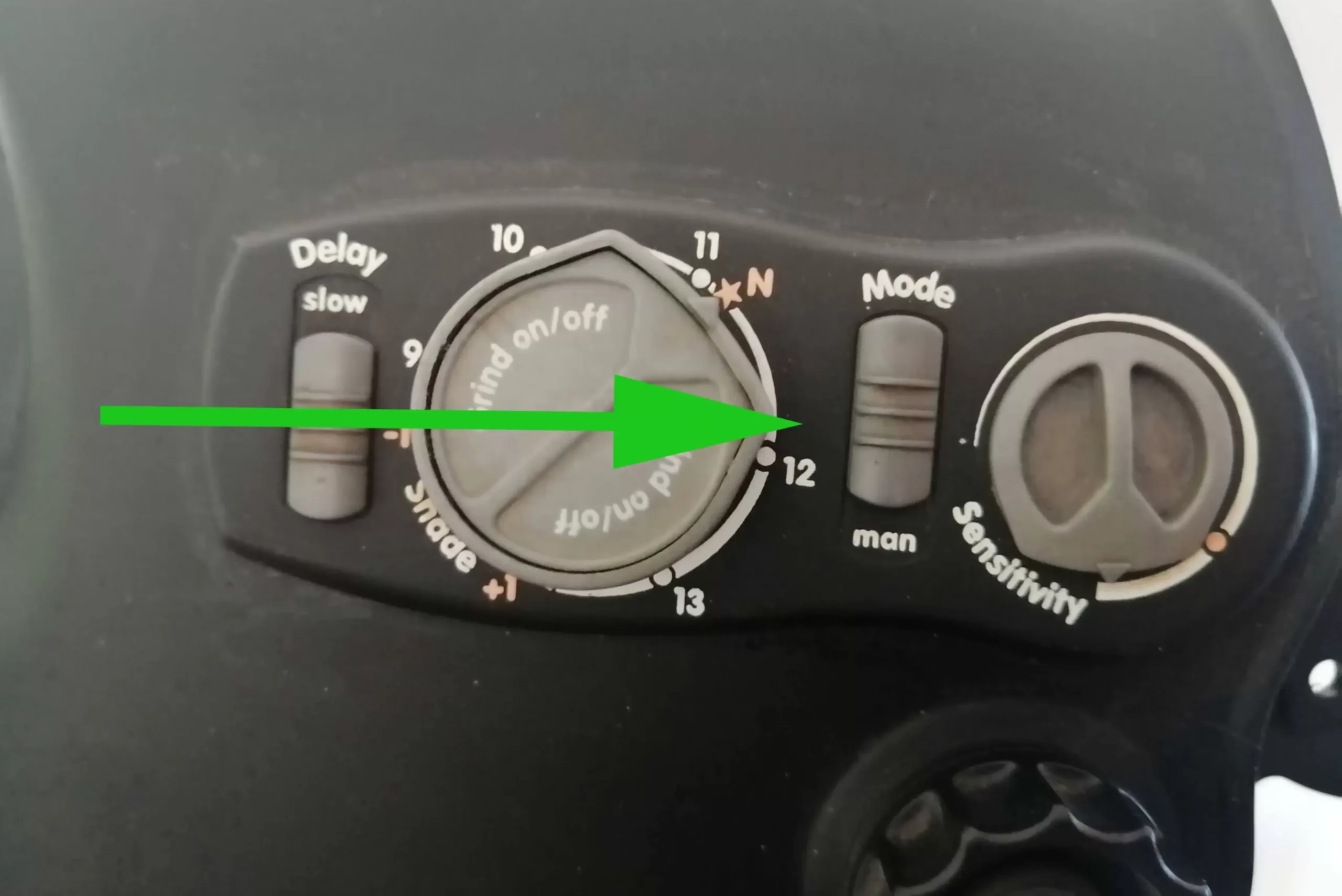 Arrow is pointing to the switch for variable or manual options on a welding helmet.