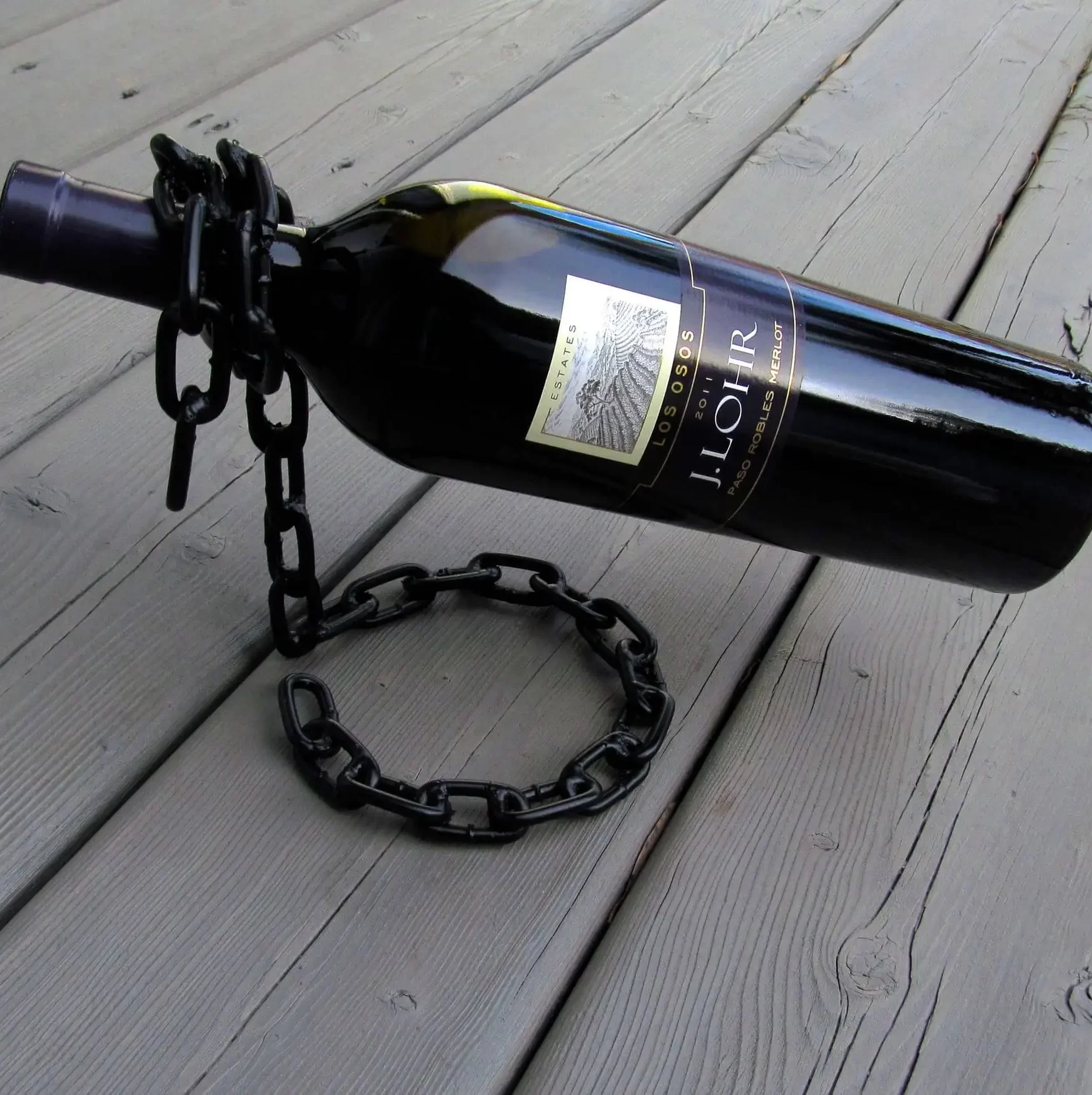 DIY wine bottle holder made from a chain welded in place