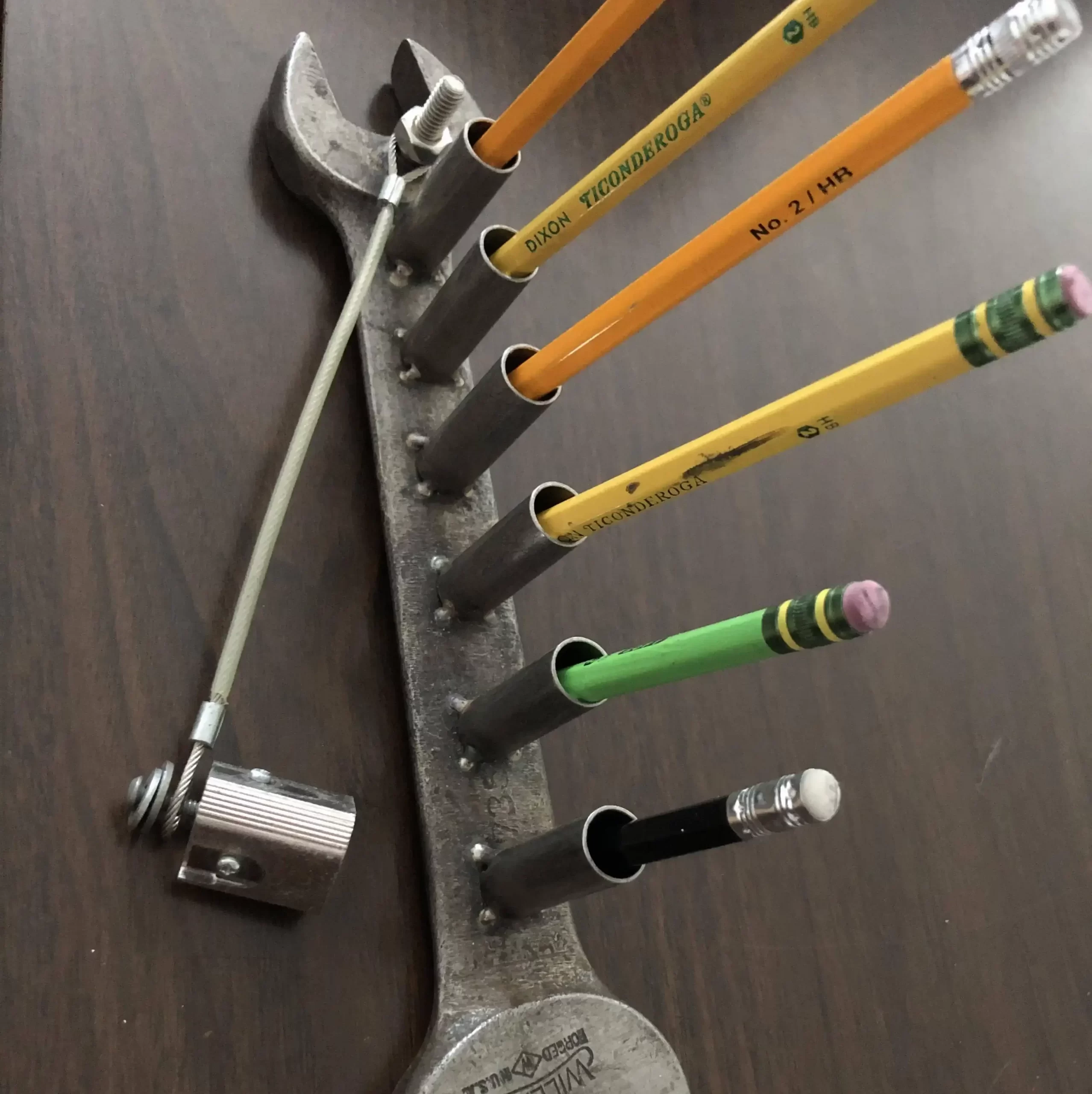Simple pencil holder made of a wrench and some tubes 