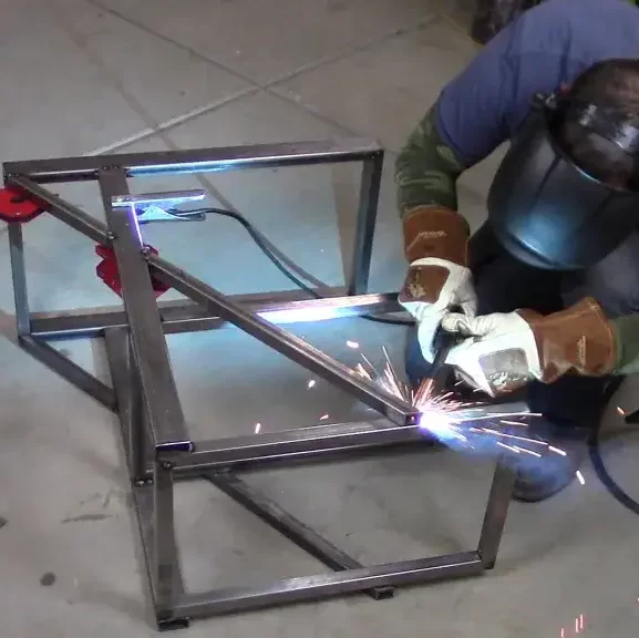 Image of a welder finishing a simple DIY welding cart for his welding machine 