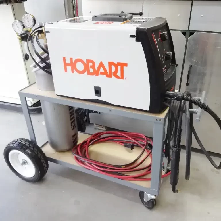 Image of a welding cart with a Hobart welding machine and a gas cylinder on it