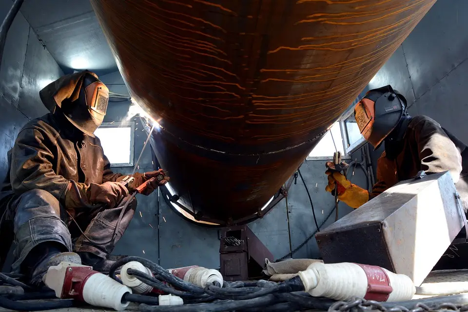 image of welders welding a pipe