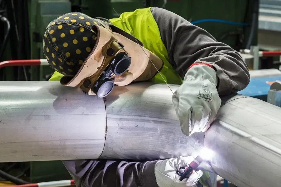 image of a welder performing a TIG weld on a pipe