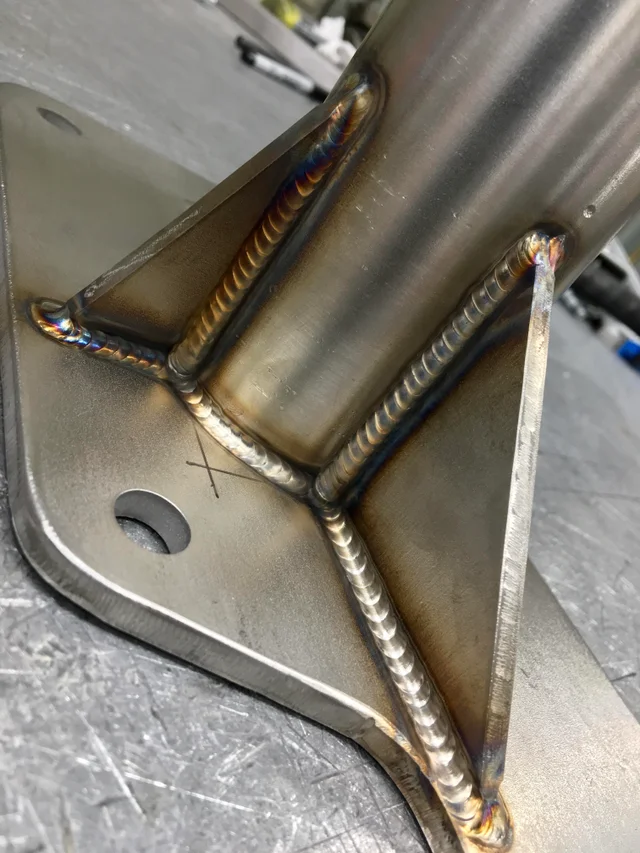 Image of a pipe and two gussets TIG welded together 