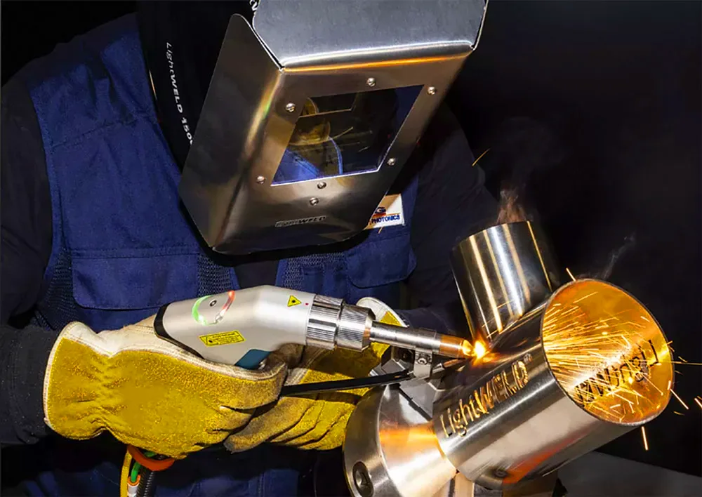 Image of a welder using handheld laser welder and cutter.