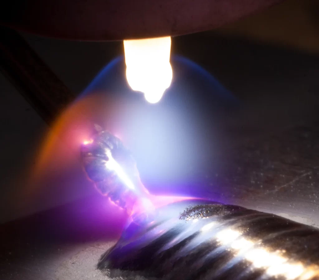 Close up of the TIG welding arc and the shielding umbrella of an Argon welding gas, welding on stainless steel