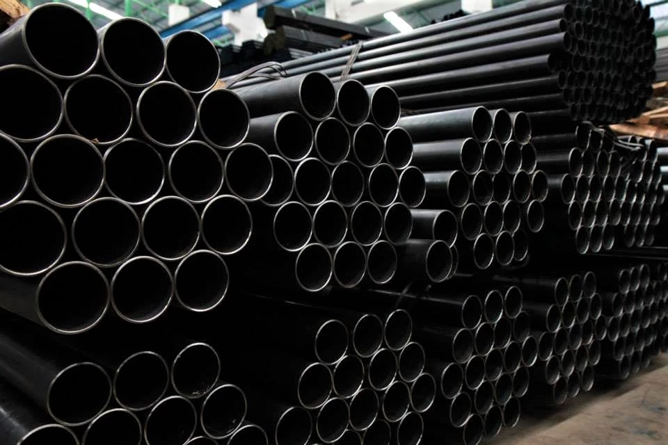 stacked black iron pipes