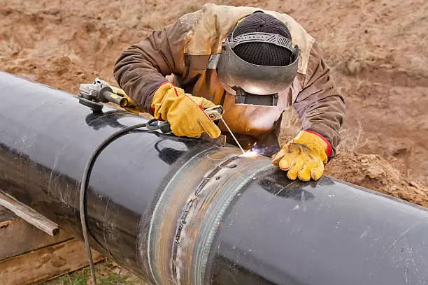 welding black iron pipe at the field
