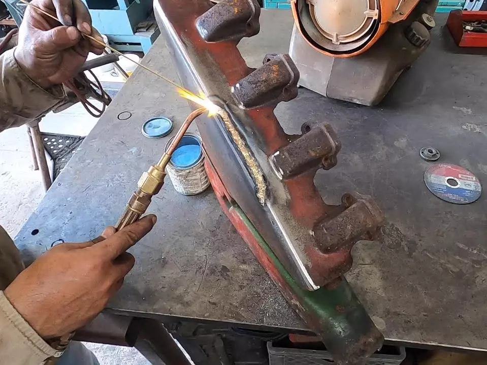 Image of brazing the cast iron part from a excavator