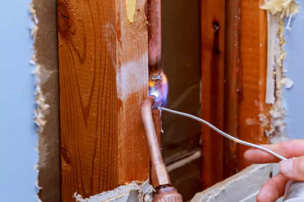 Image of brazing cupper piping inside walls 