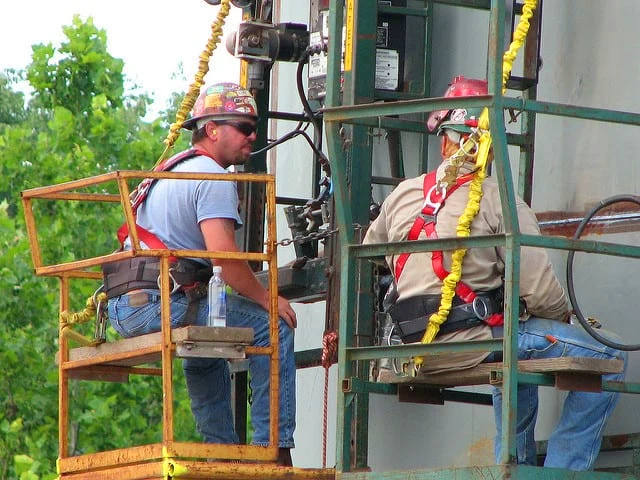 Image of welding operators performing Machine Welding or automated welding on oil tank.