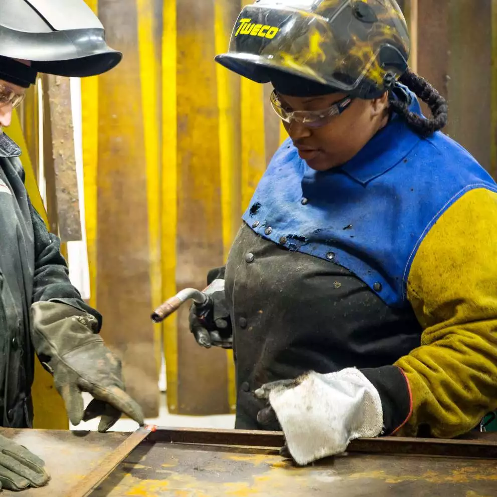 Image of two workers discussing safety