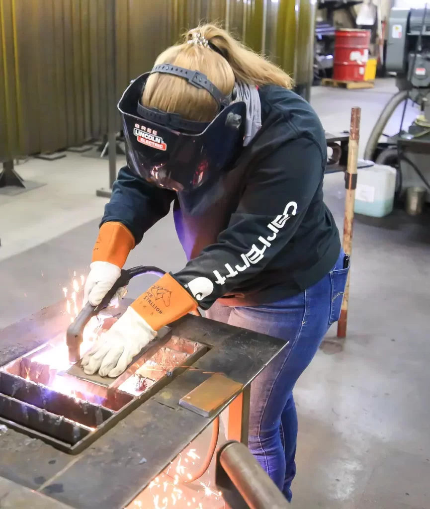 female using a plasma cutter