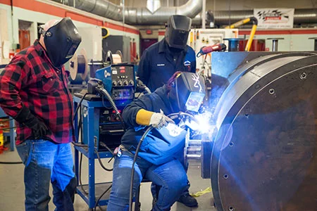 older welders helping young professionals