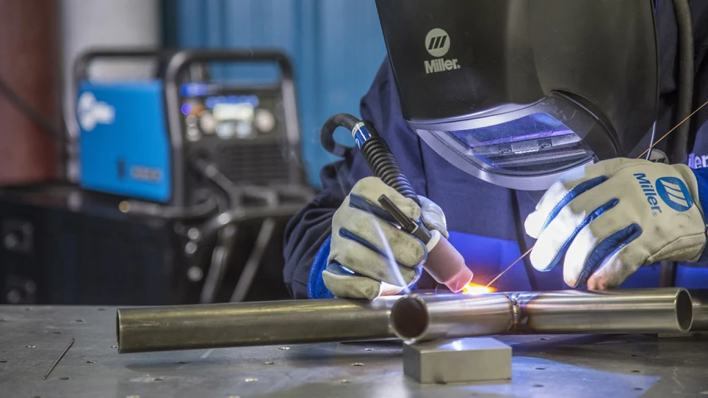 Welder working on thin pipe joints with TIG welding