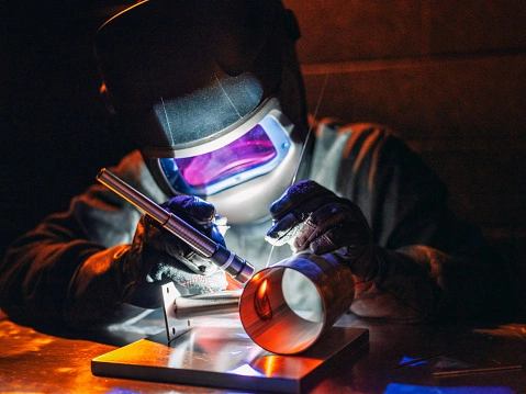 TIG Welder welding a stainless steel pipe