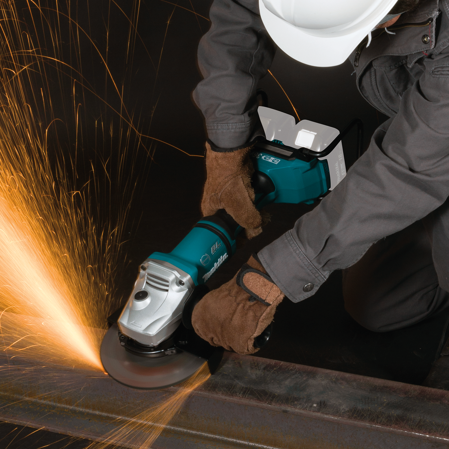 Makita XAG12Z1 grinding steel with sparks